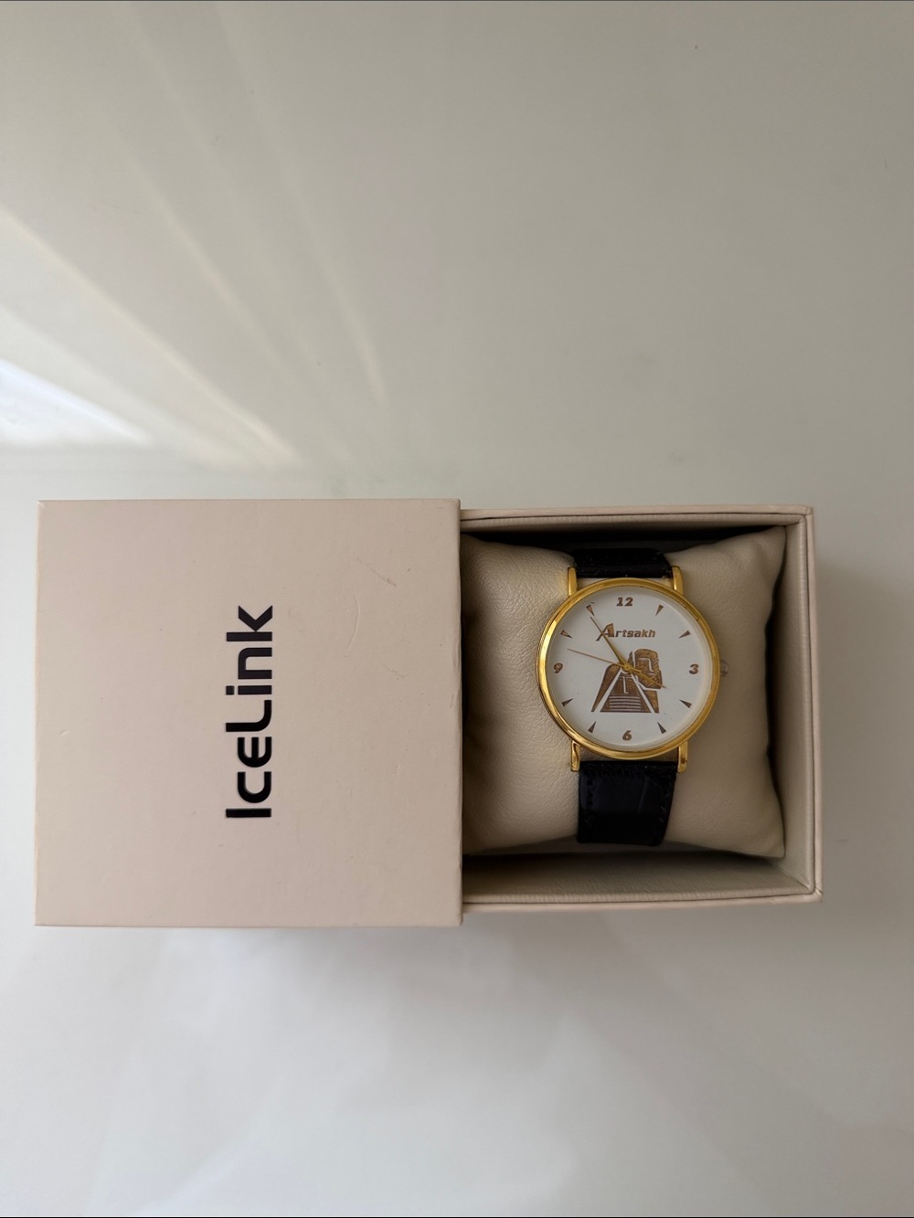 Gold Tone Watch with Black Leather Strap